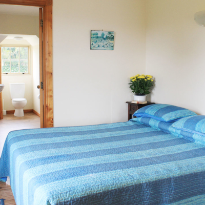 bedroom with king bed and ensuite at the carriage house kerikeri